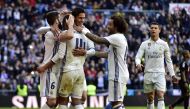 Real Madrid's Brazilian midfielder Casemiro (2ndL) is congratulated by his teammates after scoring during the Spanish league football match Real Madrid CF vs Granada FC at the Santiago Bernabeu stadium in Madrid on January 7, 2017. / AFP / GERARD JULIEN
