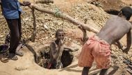 A malagasy Sapphire miner resurfaces from a hole in the ground during mining at an informal Sapphire mine on December 2, 2016 on the outskirts of Sakaraha, Madagascar. Sapphires were first discovered in Madagascar in the late 1990s, and already the Indian