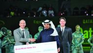Alistair Routledge, President and General Manager for ExxonMobil Qatar, presenting the cheque to Ahmad Hussain, Director of Supporting Services for Dhreima during closing ceremony of the Qatar ExxonMobil Open Tennis Tournament at the Khalifa International