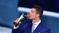 Real Madrid and Portugal's forward Cristiano Ronaldo kisses his trophy after winning the The Best FIFA Men?s Player of 2016 Award next to FIFA president Gianni Infantino during The Best FIFA Football Awards ceremony, on January 9, 2017 in Zurich. (AFP / F