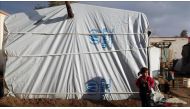 An Internally Displaced Syrian girl, fled from East Ghouta region is seen outside of a tent at a makeshift camp, relatively safer than their home neighborhoods in Damascus, Syria on January 10, 2017. ( Tarik al Masri - Anadolu Agency ).
