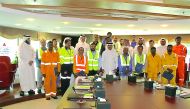 Workers and employees involved in the Project X of Kahramaa for expansion of electricity network with their certificates. 