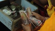 A person counting Indian currency notes (File Photo/ AFP)
