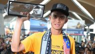 Malaysian football player Mohd Faiz Subri, an attacking midfielder for Penang FA in the Malaysian Super League, holds his 2016 FIFA Puskas Award plaque following his arrival from Zurich at the Kuala Lumpur International Airport in Sepang on January 11, 20