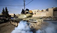 An Iraqi army T-72 tank heads to the frontline during a battle against the Islamic State (IS) group near the Fourth Bridge over the Tigris River connecting eastern and western Mosul on January 10, 2017. AFP / Dimitar DILKOFF