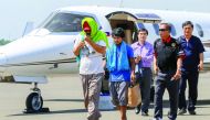 Captain Chul Hong Park (left), a South Korean national, and 2nd officer Glenn Alindajao (second left) arrive in Davao City with Philippine Peace Adviser Secretary Jesus Dureza, yesterday.