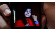 Police said 18-year-old Zeenat Rafiq (shown in the mobile phone screen ) married Hassan Khan (who holds the phone) and eloped to live with his family a week before she was killed. (AFP file photo) 