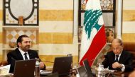Lebanon's President Michel Aoun and Prime Minister Saad al-Hariri (L) attend the first meeting of the new cabinet at the presidential palace in Baabda, Lebanon January 4, 2017. REUTERS/Mohamed Azakir