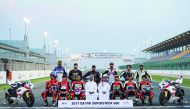 QMMF President, Abdulrahman Al Mannai and LCSC Vice President and General Manager, Khalid Al Remaihi pose for a photograph with riders after the free practice sessions of opening round of the Qatar Superstock 600 (QSTK) at Losail International Circuit yes