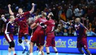Qatar's Bassel Alrayes (left), Murad Abdulrazzaq (second left), Hassan Mabrouk (right) and team-mates celebrate after they defeated Germany to enter the quarter-finals of the 25th IHF Men's World Championship Handball match at the AccorHotels Arena in Par