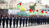Newly graduated police officers attend a parade holding Dome of the Rock model, during their graduation ceremony organised by the Palestinian Government in Gaza City, yesterday.