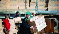 Displaced people who fled the clashes receive aid in northern Mosul, Iraq, yesterday.