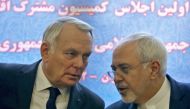 French Foreign Minister Jean-Marc Ayrault (L) and Iranian Foreign Minister Mohammad Javad Zarif smile after signing economic agreements in Tehran on January 31, 2017.  AFP / ATTA KENARE
