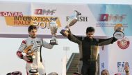 Rashed Al Naimi and Hugo Magalhaes celebrate their win at the Qatar International Rally, the first round of the FIA Middle East Rally Championship, in Doha yesterday. 