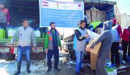 Syrian refugees receiving aid material.