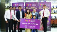 Ms. Ambika Pandey, fifth raffle draw winner of ‘Malabar Gold & Diamond Festival, receives 250 grammes of gold from Santhosh T V, Regional Head, Qatar, in the presence of  officials from Malabar Gold & Diamonds. 