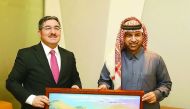 Katara General Manager Dr. Khalid bin Ibrahim Al Sulaiti (right) presents a painting as a memento to Turkish Ambassador Ahmet Demirok yesterday at Katara.