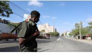 A policeman stands guard along a road that was blocked amid a security lockdown in the capital, Mogadishu, on February 7. Four hotel guards were killed by al-Shabaab militants in the port city of Bosasso. (Feisal Omar/Reuters).