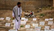 A Yemeni man visits the graves of a relative killed during clashes between Huthi rebels and fighters from the Popular Resistance Committees loyal to Abedrabbo Mansour Hadi in Taez, April 8, 2016 A(FP)