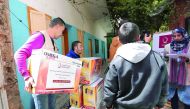 Representatives of Qatar Charity distributing lighting units to the citizens of Gaza.