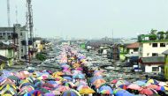 Traders cover their wares with umbrellas of different shapes and sizes along the railway line in Port Harcourt city, Rivers State, on February 14, 2017. The Nigerian city of Port Harcourt used to be known as 