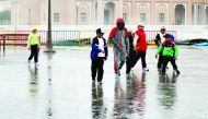 People enjoying the rain at Katara yesterday.  Pic: Kammutty VP / The Peninsula