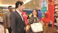 US Ambassador Dana Shell Smith admires a product with Charlie Chanaratsopon, Founder and Chief Executive of Charming Charlie, at the opening of the brand's new outlet at Mall of Qatar on Wednesday. Pic: Abdul Basit/ The Peninsula
