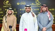 Hussain Akbar Al Baker, Director of Marketing and Communications Department at United Development Company (UDC), is seen with Saeed bin Mohammed Al-Shafi, Secretary General of Qatar Equestrian Federation (QEF), after a sponsorship signing ceremony, in Doh