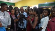 A teacher (C) at the PEFTI Film Institute teaches students to use a video camera at the school in Lagos on February 2, 2017. Nollywood film 