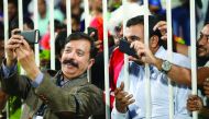 Lahore Qalandars' Qatar-based owner Fawad Rana (left) takes a selfie along with fans during  a PSL match