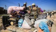 Iraqi security forces moved in convoys towards the disused airport, which lies on the southern approach to Mosul and is still held by the Islamic State group (AFP Photo/AHMAD AL-RUBAYE).