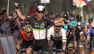 Mark Cavendish from Dimension Data team celebrates as he crosses the finish line in Madinat Zayed to win the opening stage of the 2017 Abu Dhabi Tour on February 23, 2017. / AFP / NEZAR BALOUT
