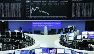 Traders work at their desks in front of the German share price index DAX board in Frankfurt?

