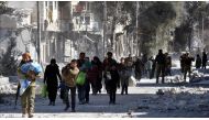 Members of Free Syrian Army (FSA) escort civilians after their victory in the Syrian town of Al Bab after the town center has been entirely freed from Daesh terrorists as part of the 