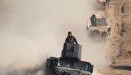 An Iraqi Special Forces soldier stands on top of a vehicle in a desert south of Mosul, Iraq February 24, 2017. REUTERS/Goran Tomasevic.