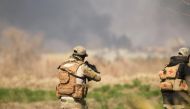Rapid Response forces members cross farm land during a battle with Islamic State's militants south west Mosul, Iraq February 24, 2017. REUTERS/Zohra Bensemra.