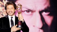 Indian Bollywood actor Shah Rukh Khan poses for a photograph with a National Yash Chopra Memorial Award in Mumbai on late February 25, 2017. AFP / STR
