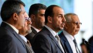 Syria's main opposition High Negotiations Committee (HNC) leader Nasr al-Hariri (2nd R) speaks to reporters after a meeting with UN Special Envoy during Syria peace talks on February 27, 2017 in Geneva. A ban on mobile phones, recording devices and 