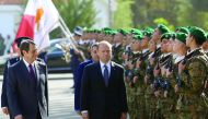 Cypriot President Nicos Anastasiades and Maltese Prime Minister Joseph Muscat review an honour guard during a welcome ceremony outside the Presidential Palace in Nicosia, Cyprus March 2, 2017. REUTERS/Yiannis Kourtoglou