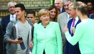 German Chancellor Angela Merkel smiles to a migrant asking for a selfie after she visited the AWO Refugium Askanierring shelter for migrants in Berlin, Germany. 