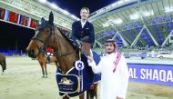 French rider Kevin Staut, astride Elky van het Indihof Hdc receives the trophy after winning the 1.50cm class at  Al Shaqab Arena yesterday.
