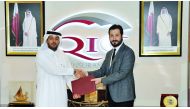 Salem Al Mannai (left) and Dr Volkan Uygunucarlar exchanging documents after signing the agreement.  Pic: Kammutty VP / The Peninsula