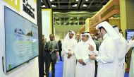 Minister of Transport and Communication, H E Jassim bin Saif Al Sulaiti (second right) visiting one of the booths during the QITCOM Conference and Exhibition which kicked off at QNCC yesterday. Pic:  Baher Amin / The Peninsula