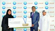 QIB officials handing a 15 years salary bonus for one of its costumers. 