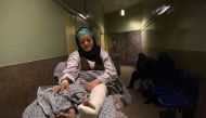 A wounded Afghan nurse waits to be X-rayed at a hospital in Kabul on March 9, 2017, after she was injured during an attack on the main military hospital in the Afghan capital. AFP / Shah Marai 