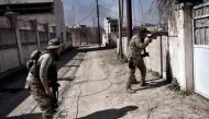 Members of the Iraqi forces patrol areas that they retook from Islamic State (IS) group fighters in western Mosul as they advance in the city in the ongoing battle to seize it from the jihadists on March 9, 2017.  AFP / ARIS MESSINIS
