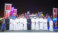Organisers of AZF and Ooredoo Qatar pose with the winning team.
