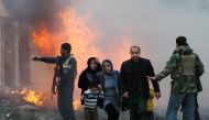 Survivors walk after a blast in Kabul, Afghanistan March 13, 2017. REUTERS/Mohammad Ismail
