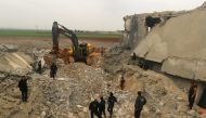 A front loader removes rubble from a damaged mosque after an airstrike on the rebel-held village of al-Jina, Aleppo province in northwest Syria March 17, 2017. (REUTERS/Ammar Abdullah)