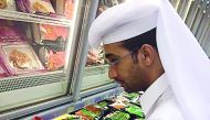 A Municipality official checking the expiry dates of products.